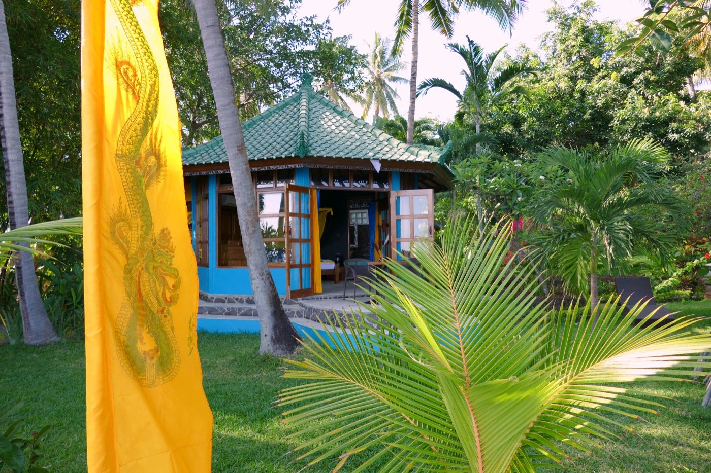 Inner Growth retreat — a tropical Balinese retreat setting with palm trees and a meditation cottage