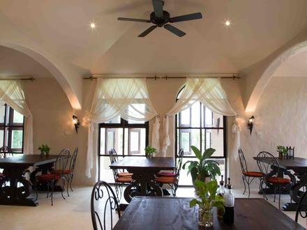 Inside Kin Dee, arched windows and long tables