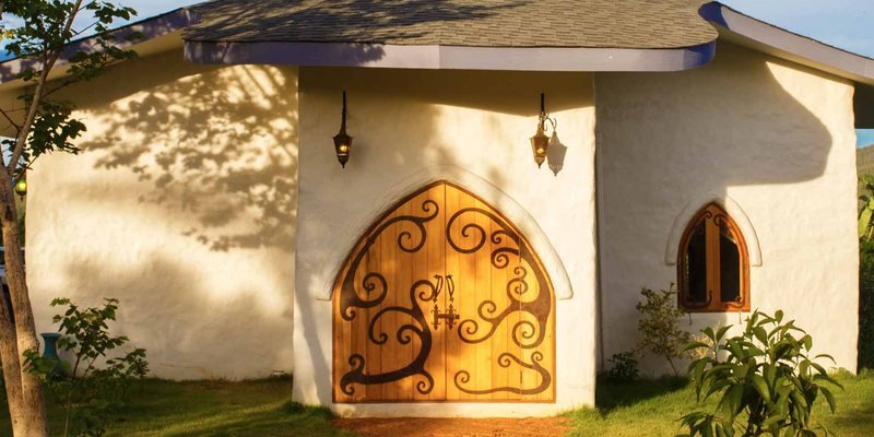 Dhara Villa — arched wooden door with ironwork