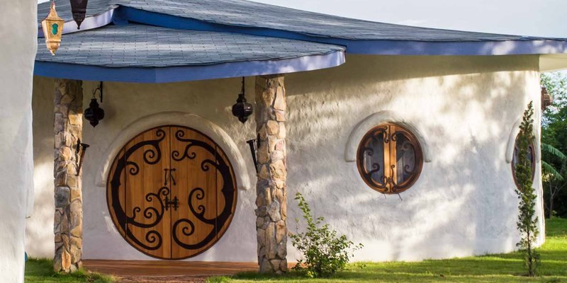 Hobbit Villa — a round wooden door with ironwork